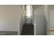 Carpeted staircase with gray walls, white trim, and curtains on the landing window at 11218 W Glenrosa Ave, Phoenix, AZ 85037