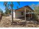 The backyard view features covered patio, desert-friendly landscaping, and bright blue cloudless sky at 115 S Stardust Ln, Apache Junction, AZ 85120