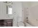 Bathroom with dark wood vanity, large mirror, tile floors and tub/shower combo at 115 S Stardust Ln, Apache Junction, AZ 85120