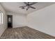 Spacious bedroom features wood-look floors, ceiling fan, a window and adjoins a full bath at 115 S Stardust Ln, Apache Junction, AZ 85120