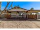 Cozy home exterior featuring a covered porch, carport, and low maintenance landscaping at 115 S Stardust Ln, Apache Junction, AZ 85120
