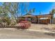 Cozy home with a covered porch, carport, and low-maintenance landscaping at 115 S Stardust Ln, Apache Junction, AZ 85120