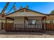 Charming house featuring a welcoming porch and adjacent carport providing convenient covered parking at 115 S Stardust Ln, Apache Junction, AZ 85120