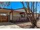Front exterior featuring a covered porch, carport, and desert landscaping at 115 S Stardust Ln, Apache Junction, AZ 85120