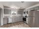 Modern kitchen features gray cabinets, stainless steel appliances, and stylish countertops at 115 S Stardust Ln, Apache Junction, AZ 85120