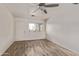 Bright, neutral living room with wood-look flooring and ceiling fan at 115 S Stardust Ln, Apache Junction, AZ 85120