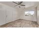 Bright room with light grey laminate flooring, modern ceiling fan and neutral wall color at 115 S Stardust Ln, Apache Junction, AZ 85120