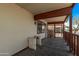 Covered front porch featuring an aged wood deck at 115 S Stardust Ln, Apache Junction, AZ 85120