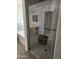 Bathroom featuring walk-in shower with glass door, tiled walls and wooden stool at 11760 N 153Rd Ave, Surprise, AZ 85379