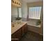 Bright bathroom featuring a large window, tile accents, and a soaking tub for relaxation at 11760 N 153Rd Ave, Surprise, AZ 85379