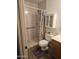 Compact bathroom featuring walk-in shower, wood vanity, and functional storage solutions at 11760 N 153Rd Ave, Surprise, AZ 85379