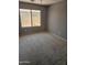Cozy bedroom featuring neutral walls, carpet floors, and a window with a backyard view at 11760 N 153Rd Ave, Surprise, AZ 85379