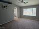 Primary bedroom featuring neutral carpet, ceiling fan, ensuite bathroom and backyard views at 11760 N 153Rd Ave, Surprise, AZ 85379