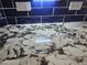 Close up of kitchen counter featuring granite countertops and navy blue backsplash at 11760 N 153Rd Ave, Surprise, AZ 85379