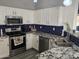 Modern kitchen with stainless steel appliances, granite countertops, and white cabinets at 11760 N 153Rd Ave, Surprise, AZ 85379