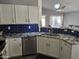 Open concept kitchen with stainless steel dishwasher, granite countertops and white cabinets at 11760 N 153Rd Ave, Surprise, AZ 85379