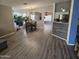Open-concept living room with wood flooring, recessed lights, and a view of the dining area and kitchen at 11760 N 153Rd Ave, Surprise, AZ 85379