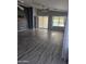 Open living room boasting modern wood panel accent wall, vaulted ceilings, and sliding door to backyard at 11760 N 153Rd Ave, Surprise, AZ 85379
