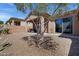 A cozy desert landscaped backyard featuring a covered patio and desert-friendly plants at 12946 N Northstar Dr, Fountain Hills, AZ 85268