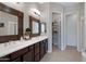 Bathroom featuring a double sink vanity, wood framed mirrors, and walk in closet at 12946 N Northstar Dr, Fountain Hills, AZ 85268