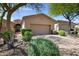 Charming home exterior with a neutral color palette, manicured landscaping, and a brick driveway leading to a two-car garage at 12946 N Northstar Dr, Fountain Hills, AZ 85268