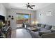 Bright living room with sliding glass doors, ceiling fan, and comfortable grey sofa at 12946 N Northstar Dr, Fountain Hills, AZ 85268