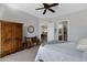 Inviting main bedroom with a ceiling fan, closet access, and antique wood furniture at 12946 N Northstar Dr, Fountain Hills, AZ 85268