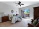 Serene main bedroom with a ceiling fan, a cozy bed, and sliding glass door to the backyard at 12946 N Northstar Dr, Fountain Hills, AZ 85268