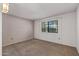 Bedroom featuring a large window and neutral carpet at 14123 W Yosemite Dr, Sun City West, AZ 85375