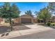 Single-story home with desert landscaping and two car garage, under a brilliant blue sky at 14123 W Yosemite Dr, Sun City West, AZ 85375