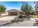 Charming single-story home with a two car garage, desert landscaping, and brick accents at 14123 W Yosemite Dr, Sun City West, AZ 85375