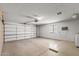 Garage with space for vehicles, storage and has a large window for natural light at 14123 W Yosemite Dr, Sun City West, AZ 85375