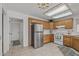 Bright kitchen features stainless steel refrigerator, white countertops, tile floors, and ample cabinet space at 14123 W Yosemite Dr, Sun City West, AZ 85375