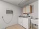 Laundry area in garage with washer, dryer, sink and bright lights at 14123 W Yosemite Dr, Sun City West, AZ 85375