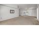 Large living room with carpet, window, decorative wall trim, and neutral paint at 14123 W Yosemite Dr, Sun City West, AZ 85375