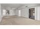 Spacious living room with a window, carpet, and sliding doors to patio at 14123 W Yosemite Dr, Sun City West, AZ 85375