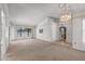 Spacious living room with large windows, neutral carpet, and a view of an adjoining dining area at 14123 W Yosemite Dr, Sun City West, AZ 85375