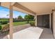 Covered patio overlooking a serene backyard, with lush greenery and beautiful landscaping at 14123 W Yosemite Dr, Sun City West, AZ 85375