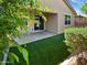 Outdoor patio area featuring artificial turf and a covered area adjacent to the home at 14154 W Voltaire St, Surprise, AZ 85379