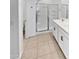 Bright bathroom featuring double sinks, white cabinets, and a glass-enclosed shower at 14154 W Voltaire St, Surprise, AZ 85379