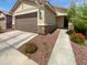 Charming single-story home featuring a two-car garage and low maintenance desert landscaping at 14154 W Voltaire St, Surprise, AZ 85379