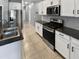 Modern kitchen featuring stainless steel appliances, granite countertops and white cabinetry at 14154 W Voltaire St, Surprise, AZ 85379