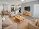 Open-concept living room and kitchen area with neutral colors, tile floors, and modern decor at 14154 W Voltaire St, Surprise, AZ 85379