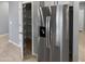 The kitchen features a stainless steel refrigerator and walk in pantry with shelving at 14154 W Voltaire St, Surprise, AZ 85379