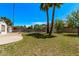 Expansive backyard, with a patio and grass, featuring mature trees and a safety-fenced pool area, great for entertainment at 1431 E San Juan Ave, Phoenix, AZ 85014
