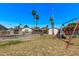 Backyard with a secure pool, complemented by a playset and mature palms, creating an outdoor Gathering retreat at 1431 E San Juan Ave, Phoenix, AZ 85014