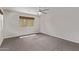 Bright bedroom with a ceiling fan and a large window with woven shade at 1431 E San Juan Ave, Phoenix, AZ 85014