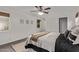 Bright bedroom offers ceiling fan, neutral walls, woven shades, carpet, and closet access at 1431 E San Juan Ave, Phoenix, AZ 85014