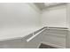 Walk-in closet with carpeted floor and white shelving at 1431 E San Juan Ave, Phoenix, AZ 85014