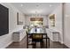 Bright dining room with built-in bench seating, dark wood floors, and a window at 1431 E San Juan Ave, Phoenix, AZ 85014
